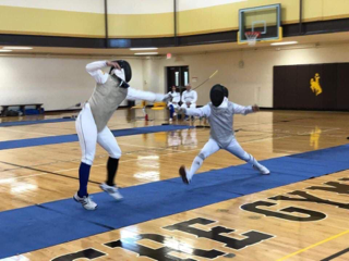 victor demonstrating lunge to students in class